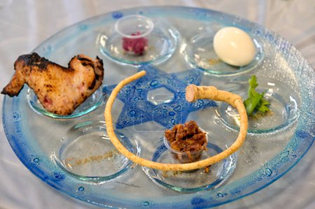 Traditional Seder plate on Passover Jewish Holiday, with six items which have significance to the retelling of the story of Passover - the exodus from Egypt, which is the focus of this ritual meal.