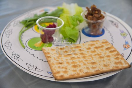 Photo for Traditional Seder plate on Passover Jewish Holiday, with six items which have significance to the retelling of the story of Passover - the exodus from Egypt, which is the focus of this ritual meal. - Royalty Free Image