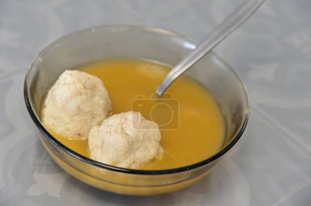 Photo for Matzah balls, Ashkenazi Jewish soup dumpling made from a mixture of matzah meal, eggs, water and chicken fat served on Passover Jewish Holiday.Food background and texture - Royalty Free Image