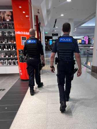 Photo for BRISBANE - APR 18 2024:Queensland Police officers patrol in shopping mall.Police across Australia are on high alert to potential terrorist attacks against civilians. - Royalty Free Image
