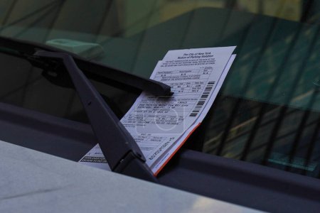 NEW YORK - NOVEMBER 3, 2022: Illegal parking violation citation on car windshield in New York