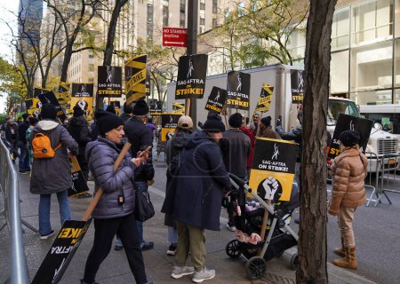 Photo for NEW YORK - NOVEMBER 2 , 2023: SAG-AFTRA members walk a picket line in front of NBC Studios in Midtown Manhattan, as 160,000 members of SAG-AFTRA continue strike - Royalty Free Image