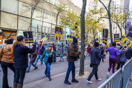Photo for NEW YORK - NOVEMBER 2 , 2023: SAG-AFTRA members walk a picket line in front of NBC Studios in Midtown Manhattan, as 160,000 members of SAG-AFTRA continue strike - Royalty Free Image