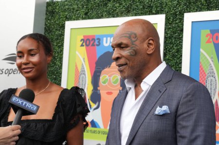 Photo for NEW YORK - AUGUST 28, 2023: Mike Tyson's Daughter Milan Tyson and former boxing champion Mike Tyson on the blue carpet before 2023 US Open opening night ceremony at USTA National Tennis Center in New York - Royalty Free Image