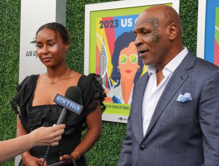 Photo for NEW YORK - AUGUST 28, 2023: Mike Tyson's Daughter Milan Tyson and former boxing champion Mike Tyson on the blue carpet before 2023 US Open opening night ceremony at USTA National Tennis Center in New York - Royalty Free Image