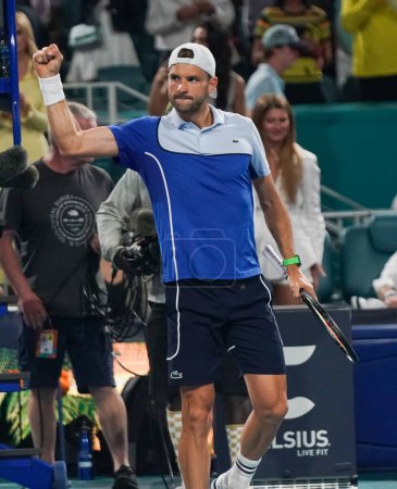 Photo for MIAMI GARDENS, FLORIDA - MARCH 28, 2024: Grigor Dimitrov of Bulgaria celebrates victory after quarter-final match against Carlos Alcaraz of Spain at 2024 Miami Open at the Hard Rock Stadium in Miami Gardens - Royalty Free Image