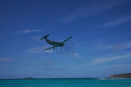 Photo for ST. BARTS, FRENCH WEST INDIES - APRIL 18, 2024: Tradewind Aviation Pilatus PC-12s plane taking off at Remy de Haenen Airport also known as Saint Barthelemy Airport. At 2,133 ft its runway is one of the shortest in the world. - Royalty Free Image