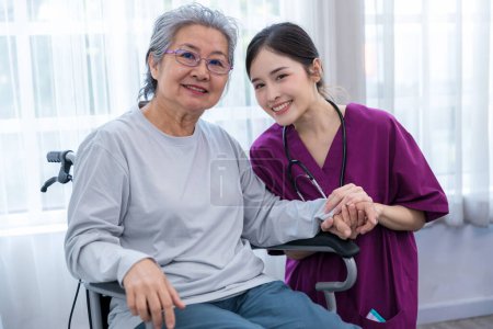 Photo for Caregiver nurse take care a Senior patient sit on wheelchair. Nurse helping senior Woman - Royalty Free Image