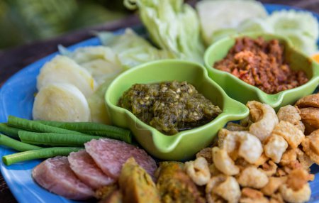 Photo for Tradition Northern Thai food. Northern Thai Green Chilli Dip thai name is "Nam Prik Num". Local food in thailand. deep fried pork skin. - Royalty Free Image