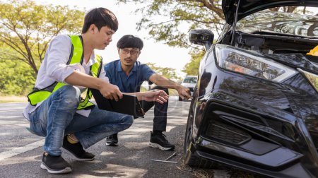 Photo for Emergency roadside assistance, technician helps with wheel replacement. Man changing wheel on a roadside. Roadside assistance - Royalty Free Image