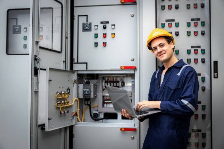 Photo for Electrical engineer working in control room. Electrical engineer man checking Power Distribution Cabinet in the control room - Royalty Free Image