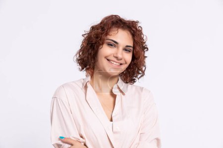 Photo for Sincere smile of a young European woman. Attractive girl with short chestnut-colored hair. Naturally curly hair. - Royalty Free Image