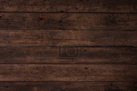 Photo for Several horizontally stacked old boards in clothes of brown color. Background of natural material slightly tattered. - Royalty Free Image