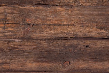 Photo for Several horizontally stacked old boards in clothes of brown color. Background of natural material slightly tattered. - Royalty Free Image