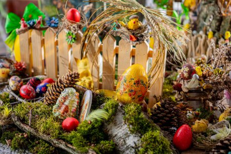 Photo for In this captivating Easter scene, a bed of moss adorned with birch bark, twigs, and vibrant Easter eggs creates a wonderland. - Royalty Free Image
