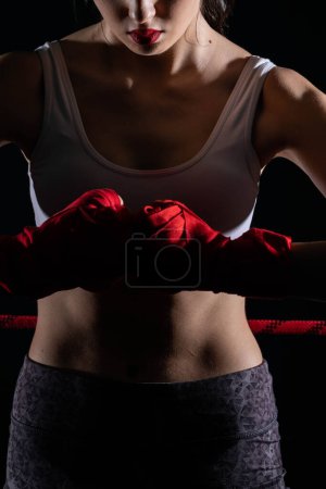 Show of strength before the start of the fight. Hands joined together with five hands together. Clenched fists of a female athlete.