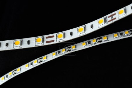 Photo for Two LED strips, 12 volts and 24 volts. Isolated on black background. Selective focus. - Royalty Free Image