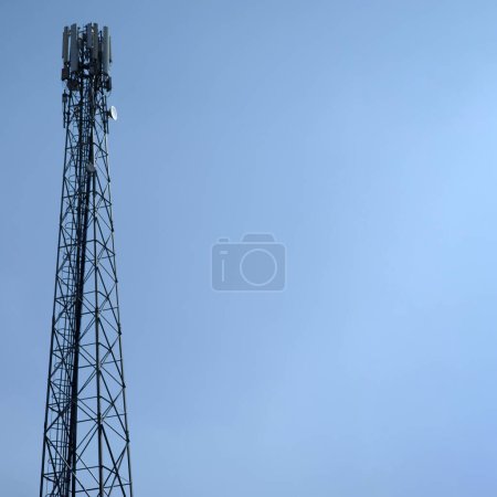 Photo for Steel tower with cellular antennas against the blue sky. - Royalty Free Image