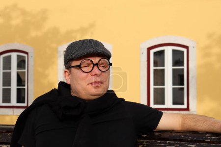 Photo for A man in a beret and toy glasses with a scar on his face. Funny forty five year old man. - Royalty Free Image
