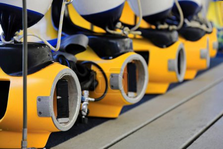 Photo for SELECTIVE FOCUS IMAGE: row of diving scooters intended for recreational use placed on the deck of a tourist pontoon moored at the Great Barrier Reef while waiting for divers. Queensland-Australia. - Royalty Free Image