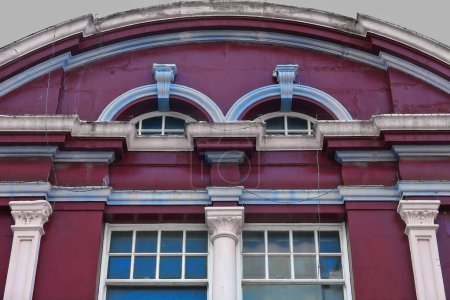 Photo for Victorian style building dating from the 1890s painted maroon-fair blue-white with small arched and big sash windows on the north side of The Corso pedestrian mall. Manly suburb-Sydney-NSW-Australia. - Royalty Free Image