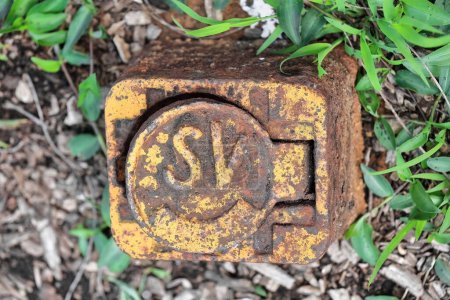 Photo for Rusty lid of a water device marked SV -sluice valve- which is an on-off tap fitted to a water pipe of the city's water supply, on the sidewalk of Glenmore Rd., Paddington suburb. Sydney-NSW-Australia. - Royalty Free Image
