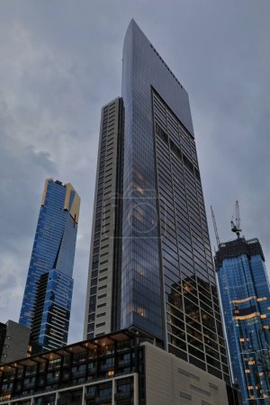 Photo for High-rise developments of apartment towers, tall office skyscrapers and hotel buildings at Southbank suburb as seen from the Yarra Promenade along the Yarra river left bank. Melbourne-VIC-Australia. - Royalty Free Image