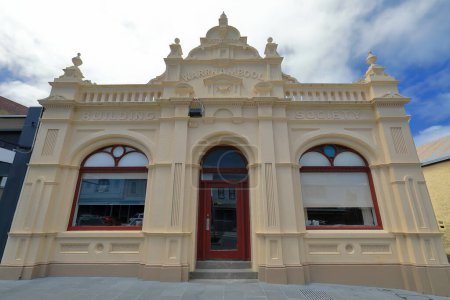 Photo for Fair beige painted rendered facade of single-story historic building from AD 1869 in the Mid-Victorian style on Liebig St., fomer seat of a long ago closed business. Warrnambool-VIC-Australia. - Royalty Free Image