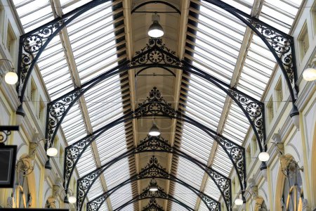 Photo for Melbourne, Australia-October 22, 2018: The Royal Arcade is a historic shopping mall opened in 1870 connecting Bourke Street to Little Collins Street. High glass roof over cast iron openwork arches. - Royalty Free Image