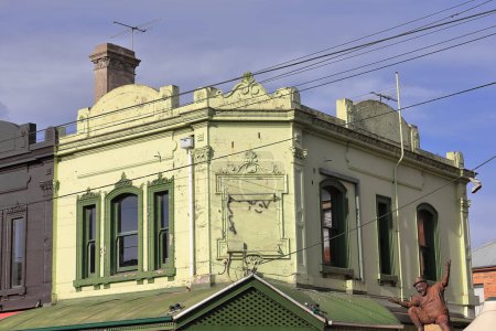 Photo for Trerraced, two-storey Victorian commercial building erected in AD 1879 at the Brunswick and Argyle streets NE corner of yellow-green cement rendered brickwork. Fitzroy suburb-Melbourne-VIC-Australia. - Royalty Free Image