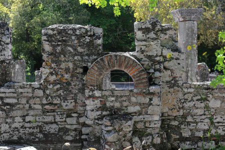 Photo for Remains of a round-arch window on the outer wall of the VI century AD dated circular structure of the baptistery with columns around a central font, Butrint archaeological site. Vlore county-Albania. - Royalty Free Image