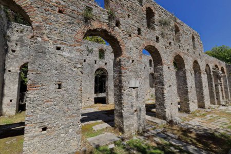 Photo for Brickwork-made round arches on the central aisle southern wall, great basilica built between the 5th century AD end and the 6th century AD beginning, Butrint archaeological site. Vlore county-Albania. - Royalty Free Image