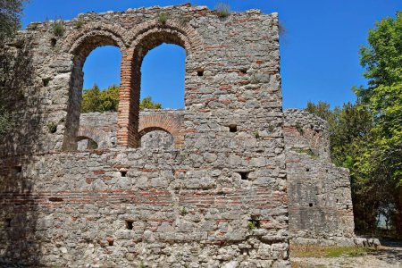 Photo for Brickwork-made round arches on the southern aisle outer wall, great basilica built between the 5th century AD end and the 6th century AD beginning, Butrint archaeological site. Vlore county-Albania. - Royalty Free Image