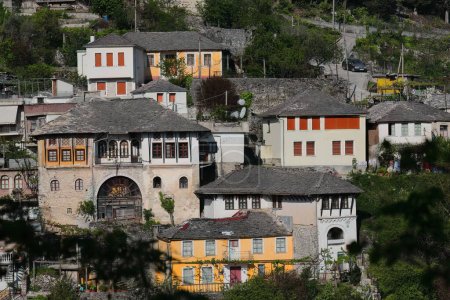 Hillside Ottoman style houses dating from the XVII-XVIII centuries built with stone blocks and featuring roof covers of flat dressed stones, westwards view from the city fortress. Gjirokaster-Albania.