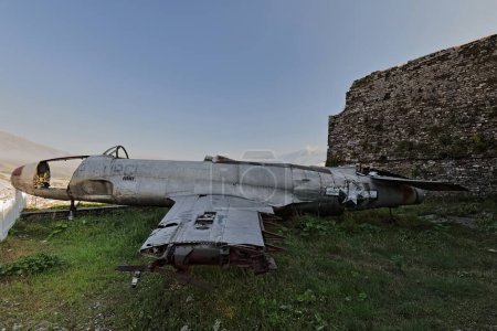 Photo for Old U.S. military Lockheed T-33 Shooting Star airplane landed and abandoned in Tirana airport in 1957, since 1970 on display at the top of the citadel as part of the Arms Exhibit. Gjirokaster-Albania. - Royalty Free Image