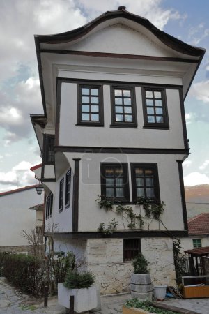 Photo for Ottoman-style old house of width-increasing floors from the XIX century in Varos -Old town- neighborhood that served as a model for the street lanterns still in use in the city. Ohrid-North Macedonia. - Royalty Free Image