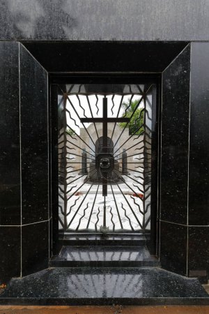 Entrance door to a pantheon, iron grate featuring the motto 'rogad por nosotros gracias-como amareis sereis amados:pray for us thank you-as you will love you will be loved'. Colon Cemetery-Havana-Cuba