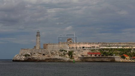 AD 1589 built Castillo de los Tres Reyes del Morro Castle on designs by Italian engineer Battista Antonelli at the port entrance, as seen from Old Town on the opposite side of the harbor. Havana-Cuba.