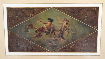 Cienfuegos, Cuba-October 11, 2019: Allegorical-mythological painting showing semi-nude women and a celestial winged being -cherub- in a heavenly scene, ceiling of the AD 1889 built Tomas Terry Theater