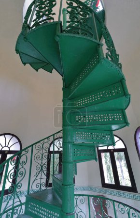 Photo for Cienfuegos, Cuba-October 11, 2019: Green-painted spiral staircase going to the lookout atop the turret on the former Palacio de Valle Palace NW corner, nowadays a restaurant open to the general public - Royalty Free Image