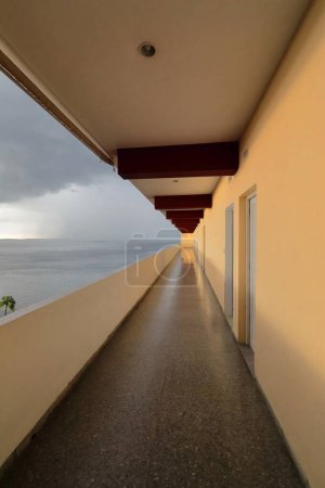 Photo for The open gallery leading to the rooms in the Jagua Hotel, views to the stormy sky over Jagua Bay after heavy tropical downpour. Cienfuegos-Cuba-207 - Royalty Free Image