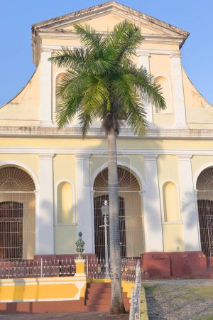 Foto de Trinidad, Cuba-12 de octubre de 2019: Fachada orientada al suroeste del año 1892 d.C. Terminada Iglesia Parroquial de la Santisima Trinidad-Iglesia de la Santísima Trinidad en el lado norte de la Plaza Mayor. - Imagen libre de derechos