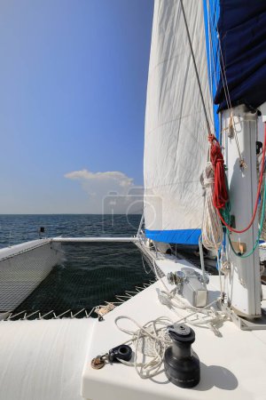 Photo for Bow, trampoline and headsail of a cruising catamaran on its midday journey back from the small, sandy Cayo Iguana Key off the south shore of the main island at two-hour boat sail away. Trinidad-Cuba. - Royalty Free Image