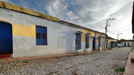 Trinidad, Cuba-October 13, 2019: West-southwestward view from Calle Amargura Street along the sloping, cobbled Calle San Jose Street until the transversal Calles Cristo and Real del Jigue Streets.