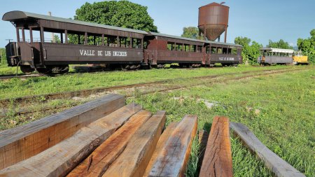 Photo for Trinidad, Cuba-October 14, 2019: Wood cars of the Valle de los Ingenios-Sugar Mills Valley historic train at the station next to a water tower before starting its daily round trip to the plantations. - Royalty Free Image