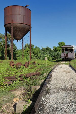 Trinidad, Cuba-October 14, 2019: Wood cars of the Valle de los Ingenios-Sugar Mills Valley historic train at the station next to a water tower before starting its daily round trip to the plantations.