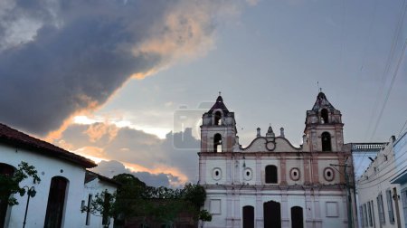 Camaguey, Cuba-October 15, 2019: Southeast facing Baroque facade of the AD 1825 built, two-towered Iglesia Nuestra Senora del Carmen-Our Lady of Carmen Church on Plaza del Carmen Square, at twilight.