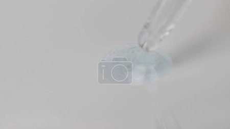 Photo for Grayscale macro shot of gel with tiny bubbles of various sizes flowing out of a pipette. Abstract skin care gel with hyaluronic acid composition concept. - Royalty Free Image