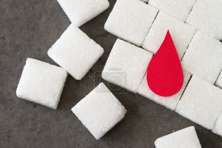 Foto de Sugar cubes with red blood drop, diabetes concept - Imagen libre de derechos