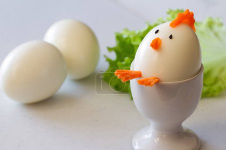 Photo for Easter chicken made of hard boiled egg in egg cup, funny appetizer easter - Royalty Free Image